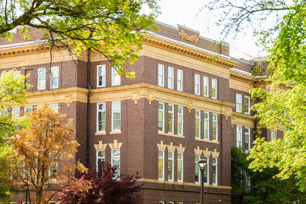 outside image of Pittsburg State's Russ Hall with green trees around